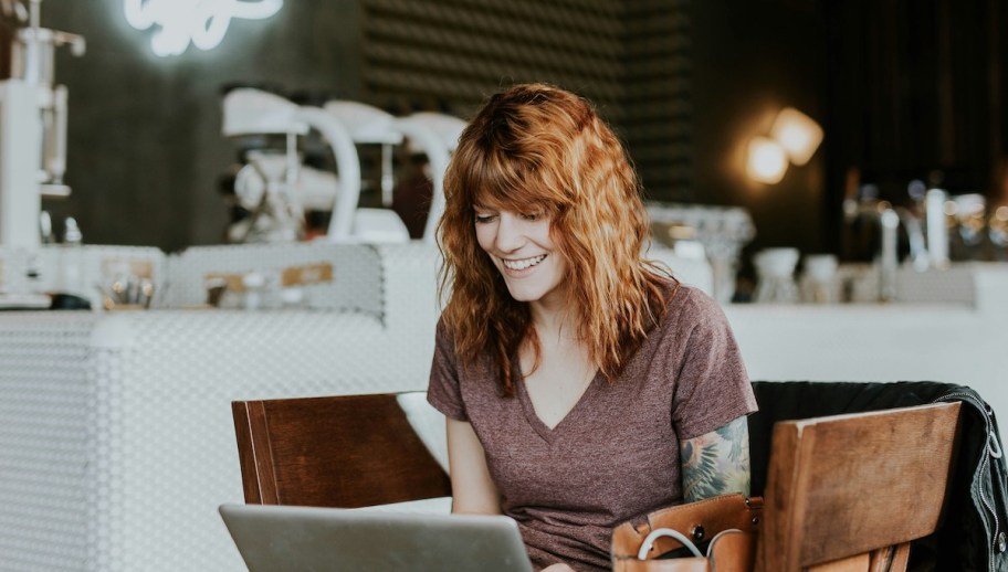 Woman sitting on laptop and coffee shop 