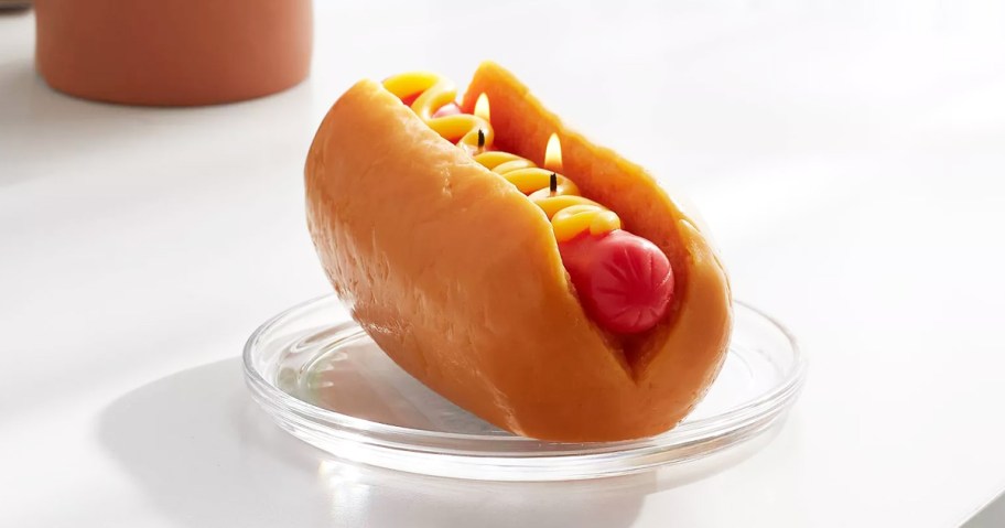 hot dog in bun shaped candle on a plate