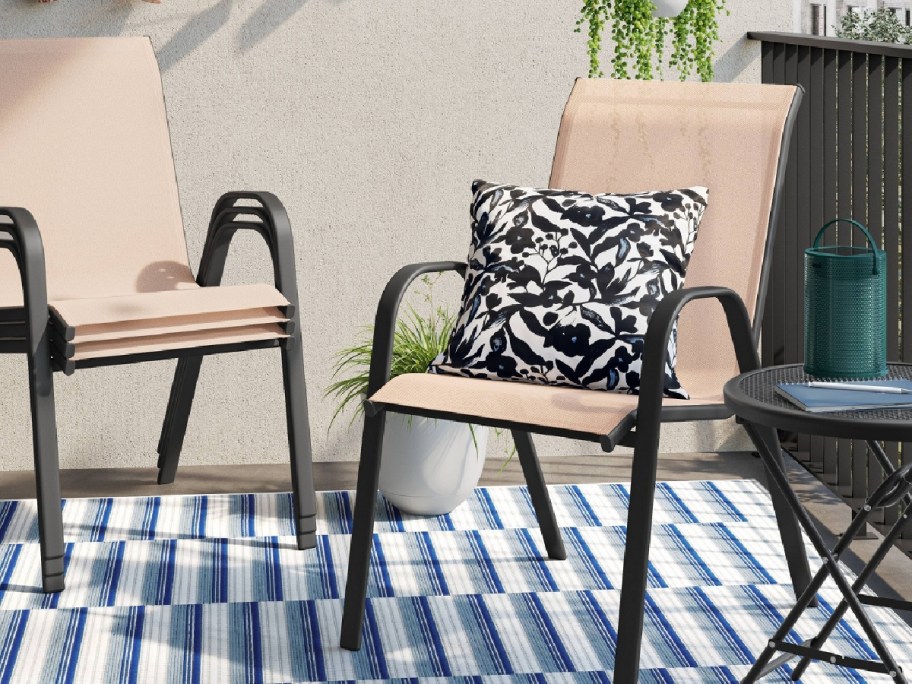 tan outdoor seating with cushion and rug underneath