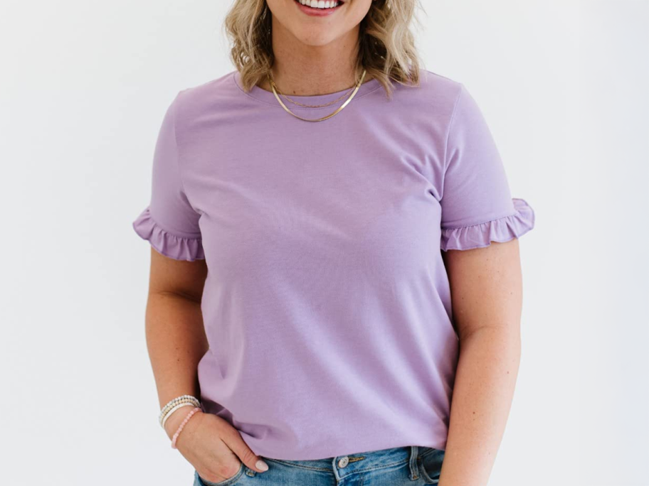woman wearing a light purple ruffle sleeve top