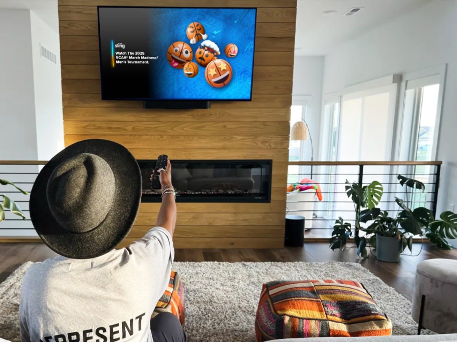 woman using remote to watch March Madness on tv