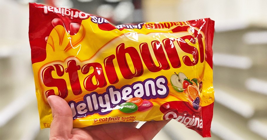 hand holding up a bag of Starburst Jelly Beans