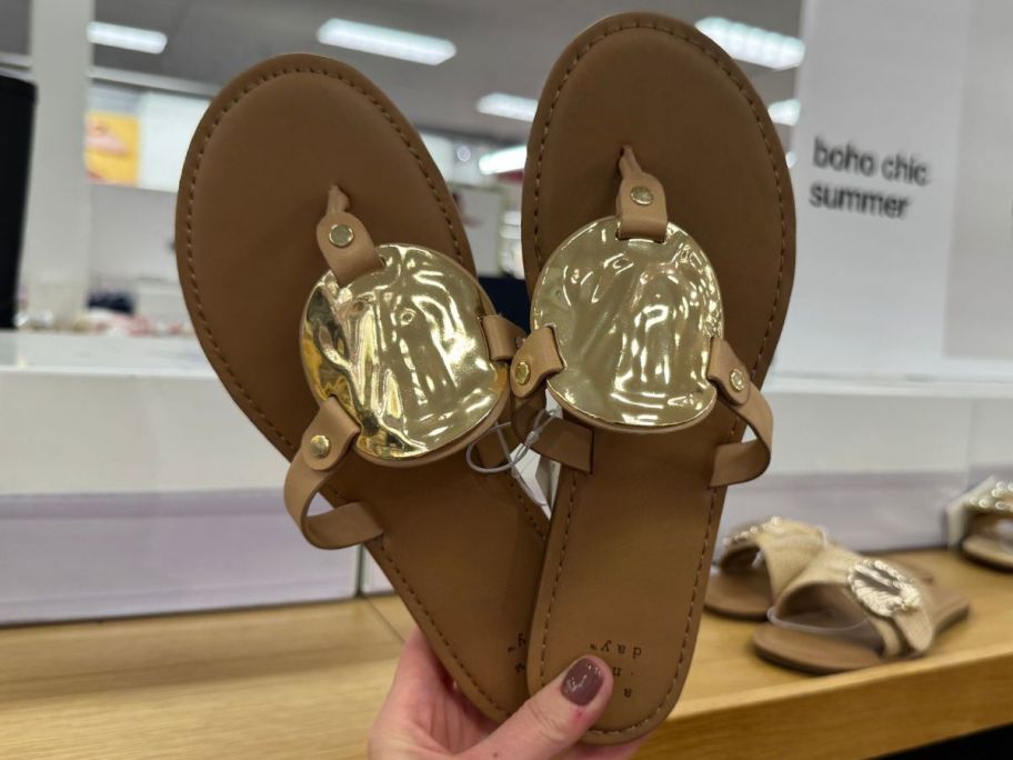 Hand holding a pair of A New Day Women's Layla Ornament Thong Sandals 