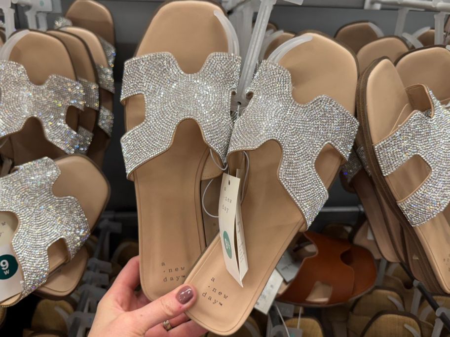 Hand touching a pair of A New Day Women's Nina Rhinestone Flat Sandals