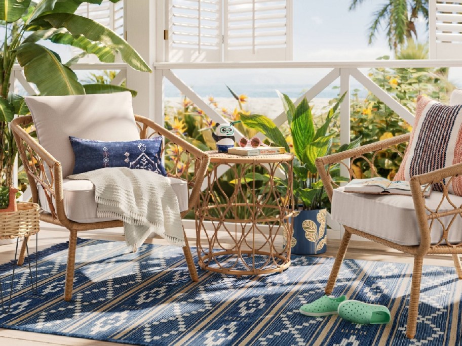 outdoor seating 2 piece chairs on a blue rug with middle table 