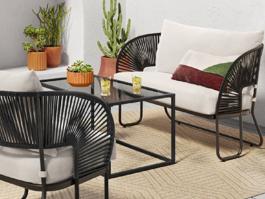 loveset on a rug with a center table and chairs