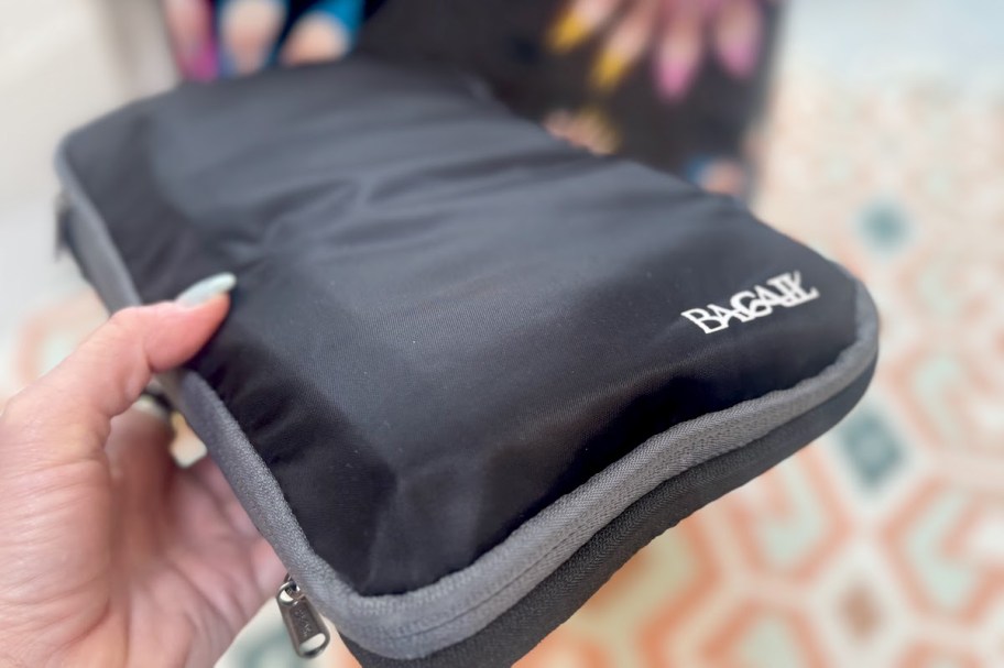 hand holding black compression packing cube