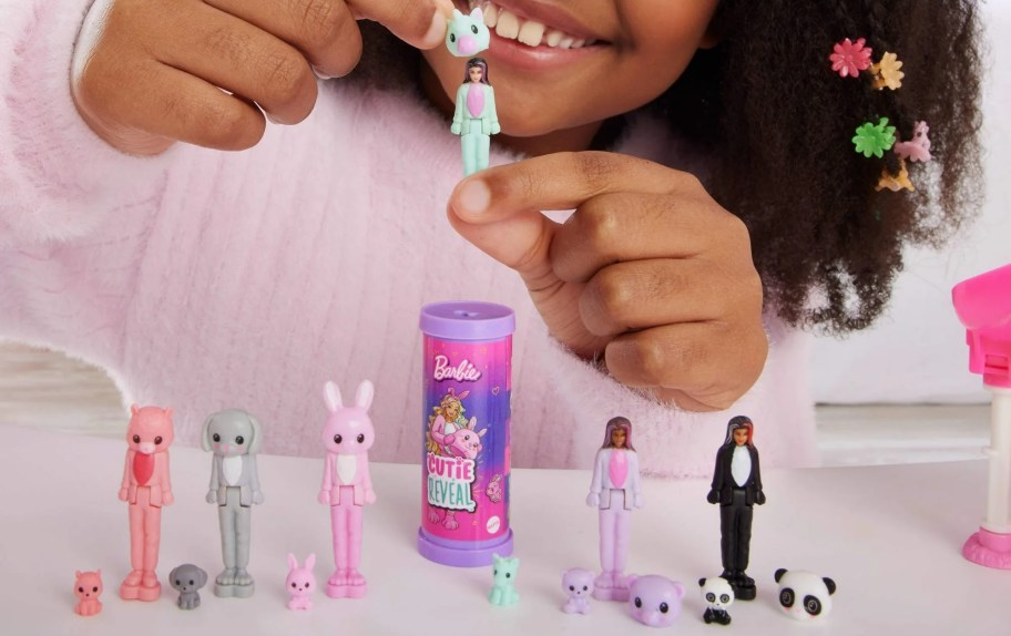 hand holding mini figure of BarbieLand doll