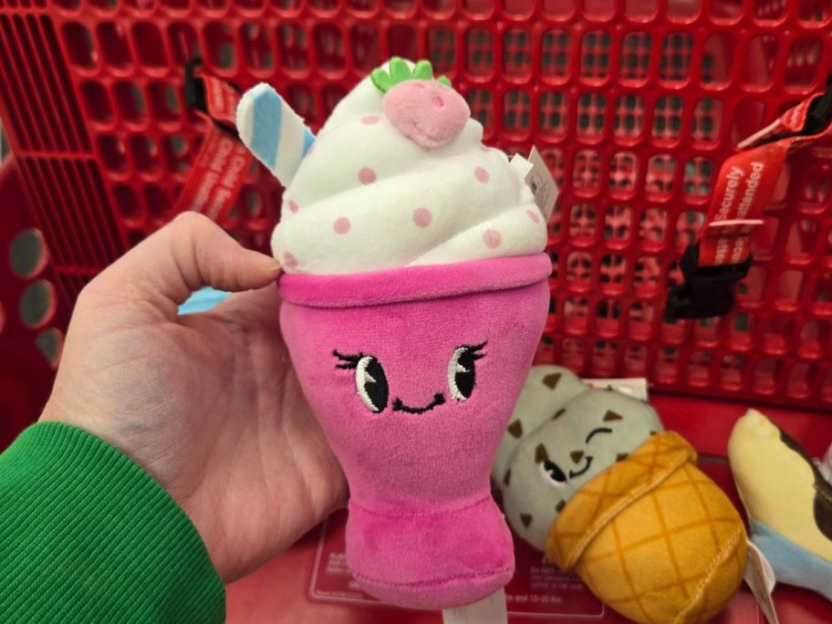 pink shake plushie in hand in store