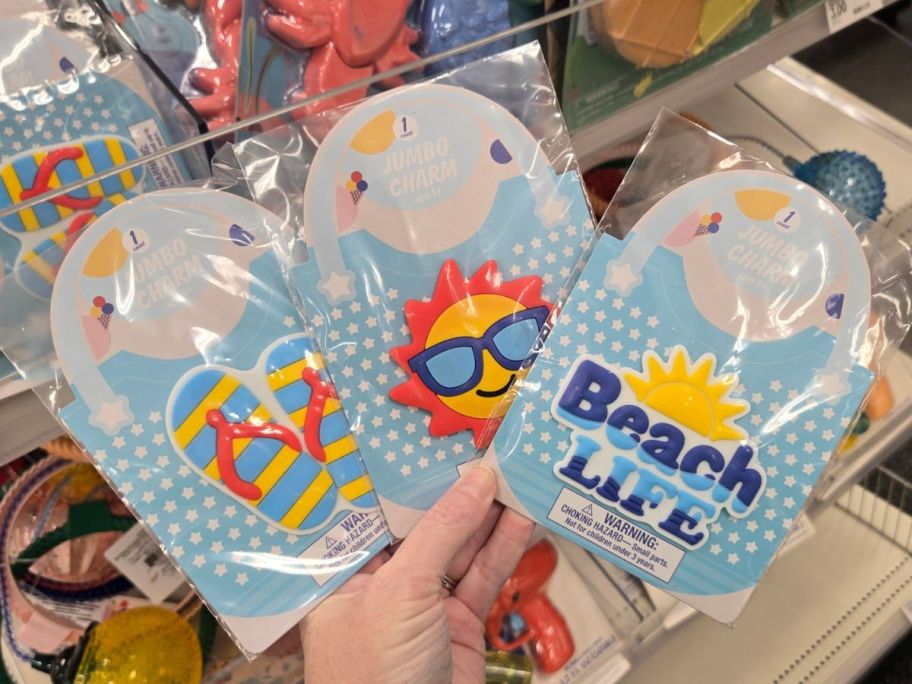 three jumbo charm packages in hand in store