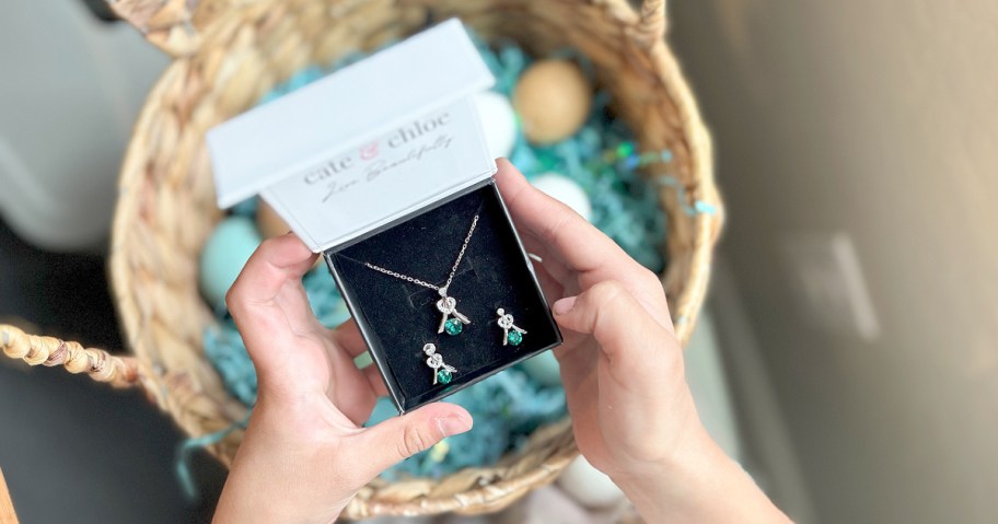 girl holding a jewelry set over a basket