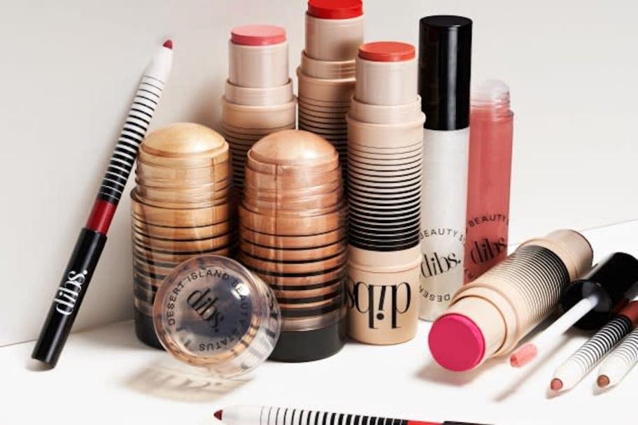 Collection of Dibs makeup products on white countertop 