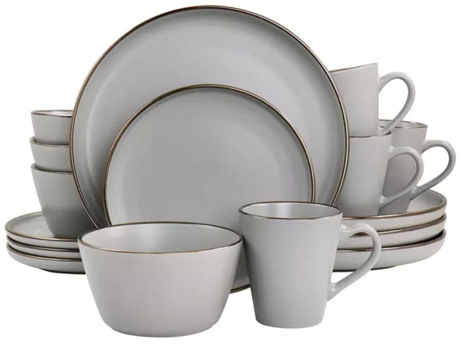 grey Elama Simon 16-Piece Stoneware Dinnerware Set with a gold rim stock image