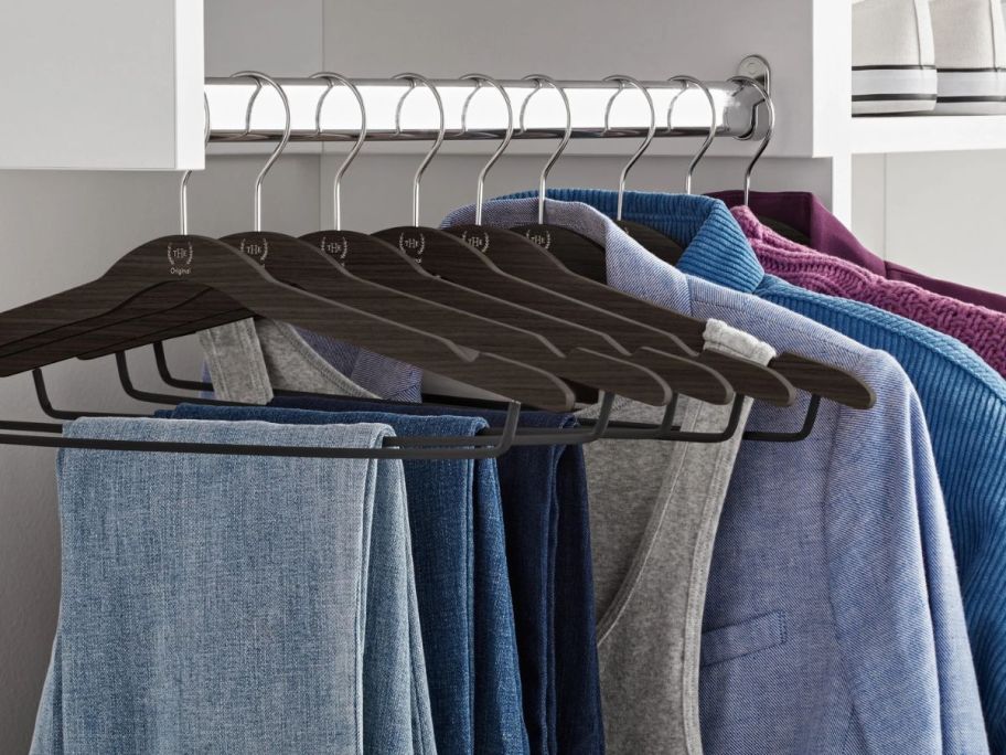 The Home Edit Thin Clothing Hangers in closet with clothes hanging off of them