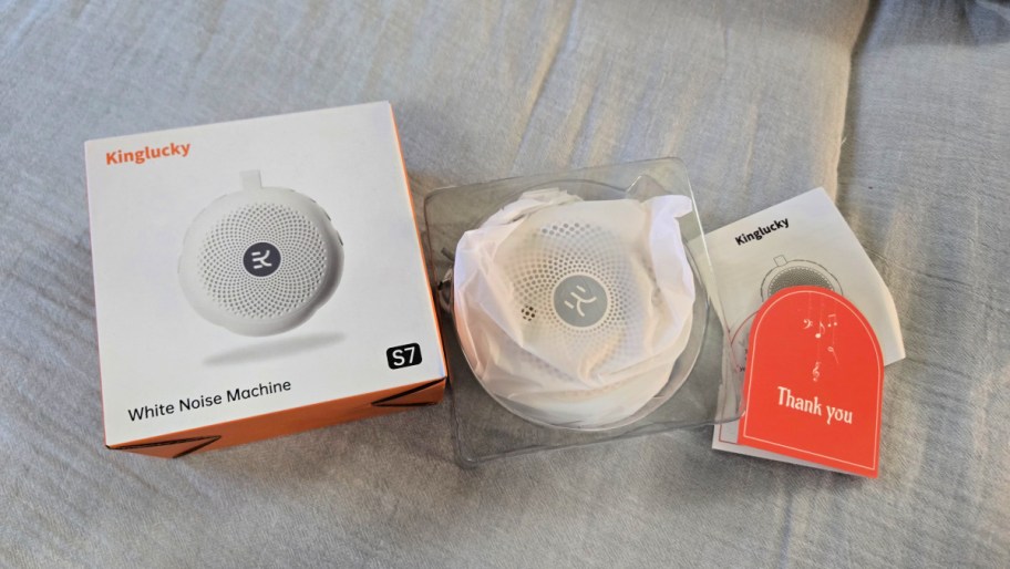 white noise machine with packaging next to the box