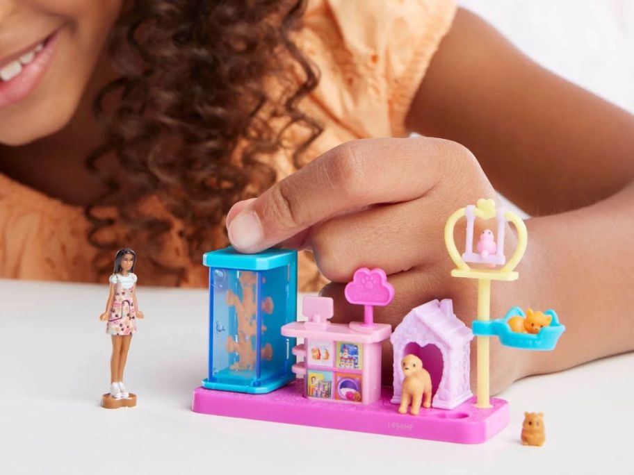girl playing with Barbie Mini BarbieLand Pet Boutique Playset