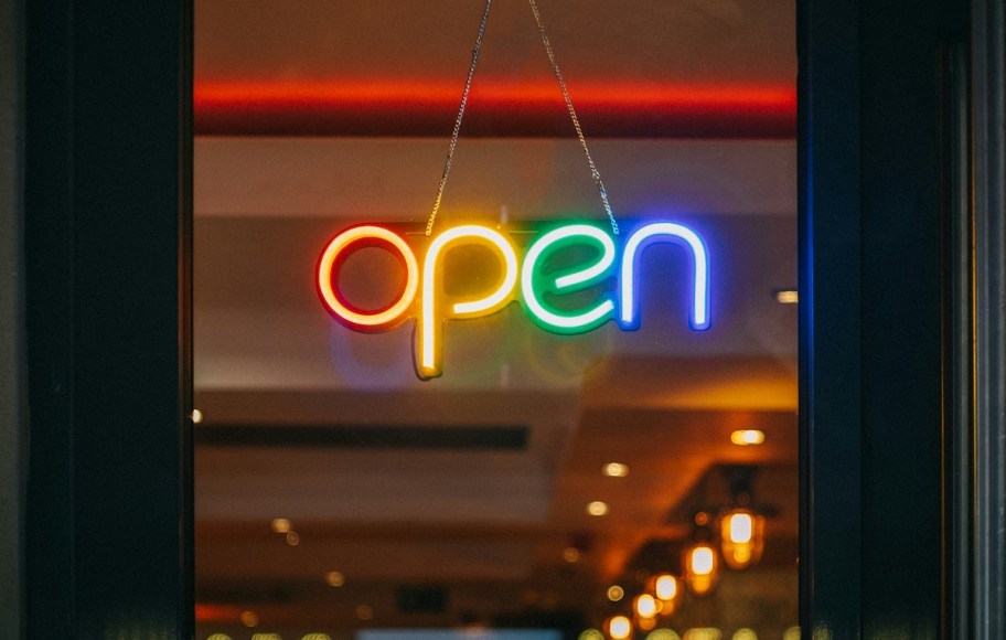 rainbow neon open sign on glass door
