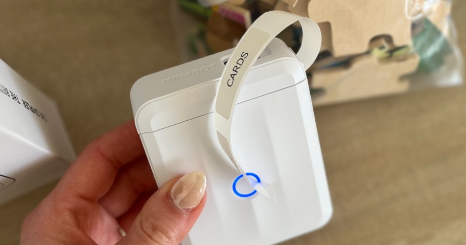 hand holding a digital label maker in white