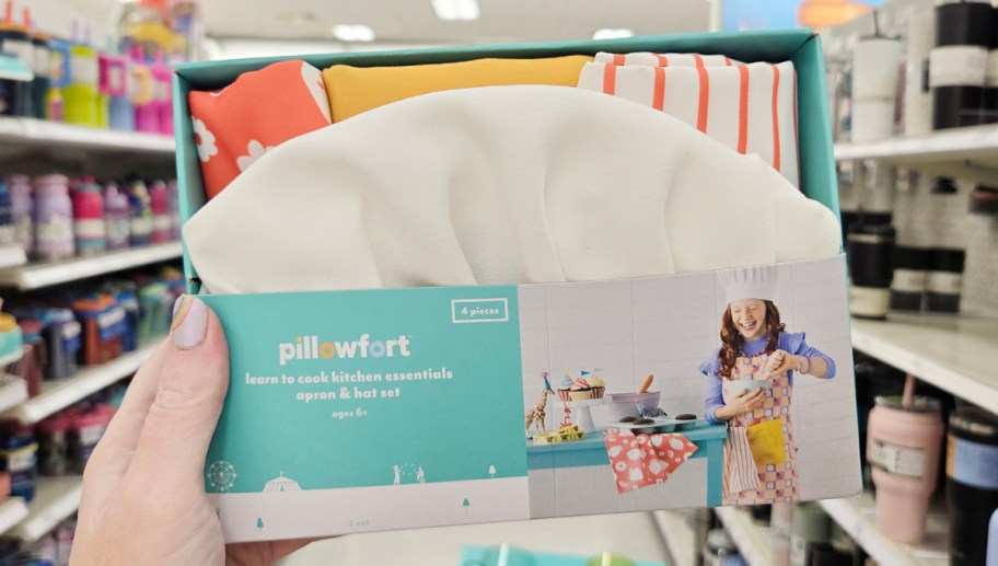 hand holding girls pillowfort apron set 