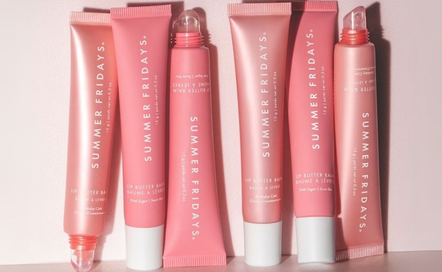 A grouping of pink tubes of Summer Fridays Lip Butter Balms in birthday cake and cotton candy shades