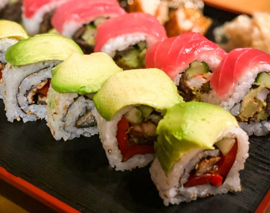 sushi with avocado and salmon on plate