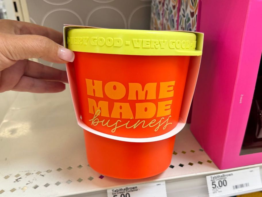 yellow and orange Tabitha Brown Ice Cream Container in hand in store