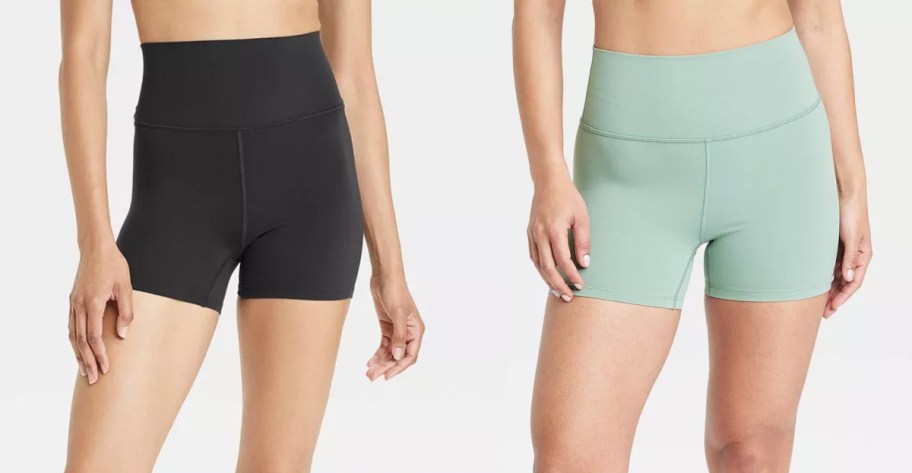 two women wearing black and green bike shorts