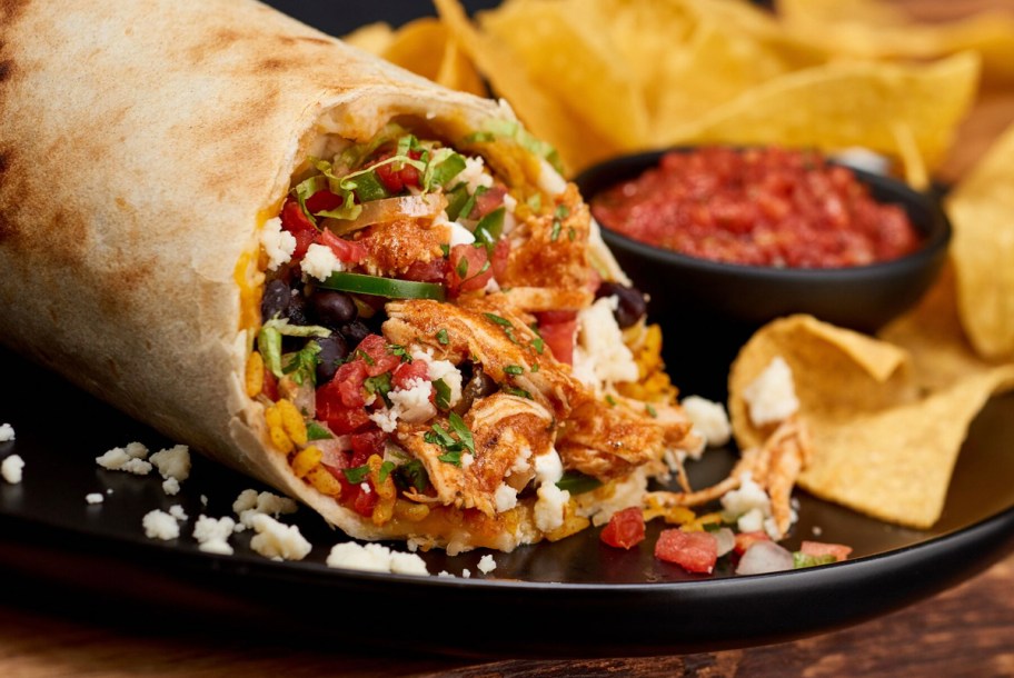 tijuana flats burrito on plate with chips 