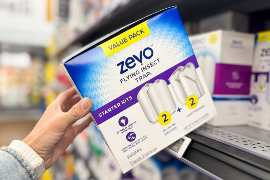hand grabbing zevo bug trap box off walmart shelf