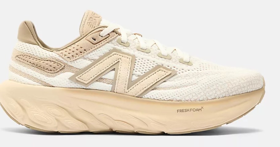 a white and peach adults New Balance sneaker