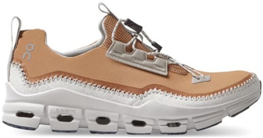 a brownish and white color On running shoe