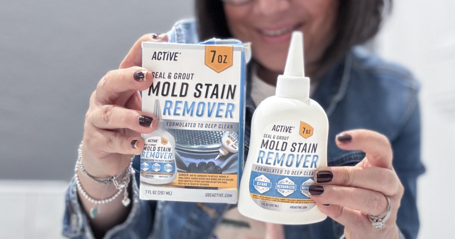 woman holding up a bottle of Active Mold Grout Gel Cleaner