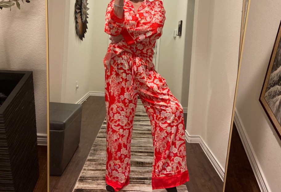 Woman wearing Amazon silk pajamas in red, in her walk way