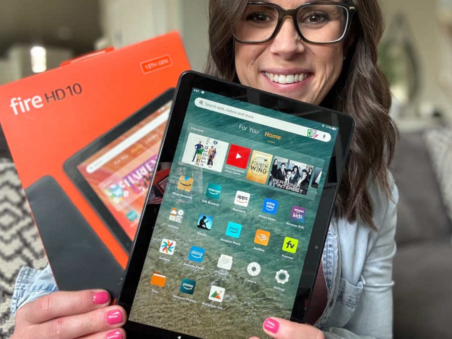 Woman holding an amazon tablet in front of her