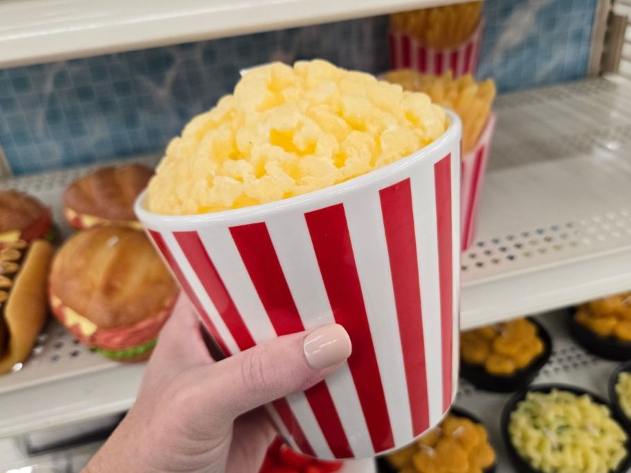 A candle that looks like popcorn in a bucket
