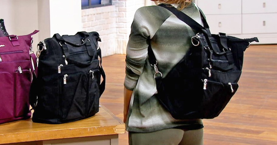 woman in a green striped sweater with a black backpack