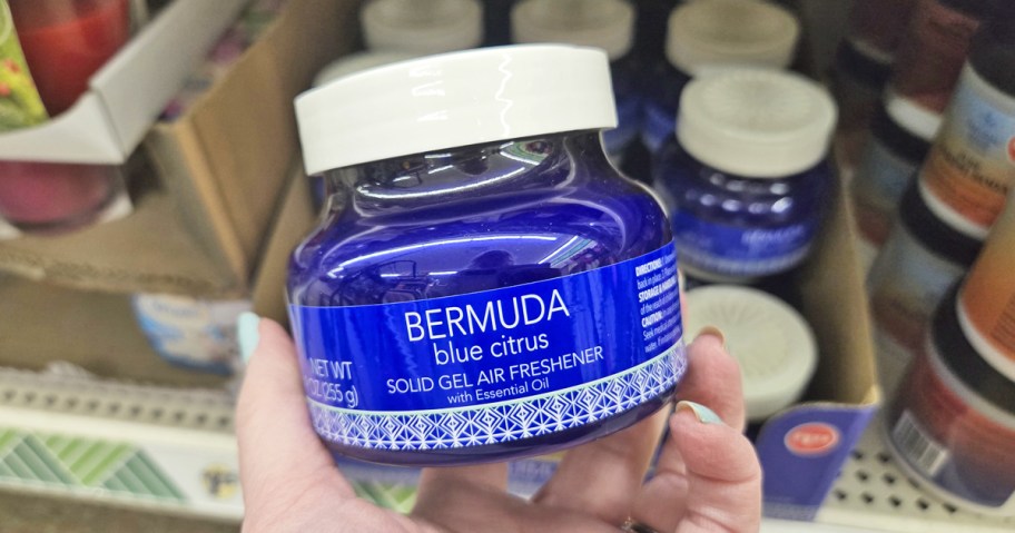 hand holding blue jar of Bermuda Blue Citrus Solid Air Freshener in store