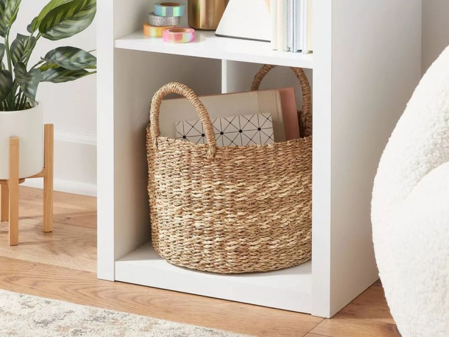 A Brightroom Seagrass Storage Basket in a cube shelf