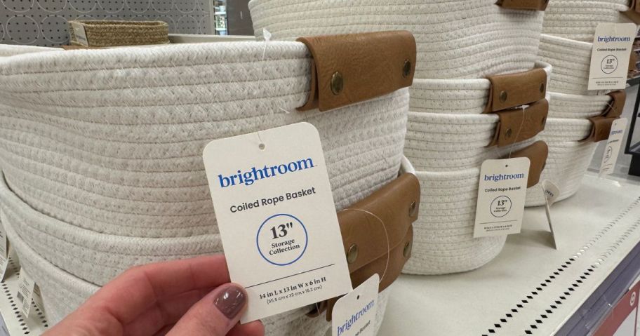 Hand touching the tag on a Brightroom Coil Rope Storage Basket