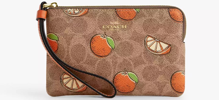 brown coach wristlet with oranges print