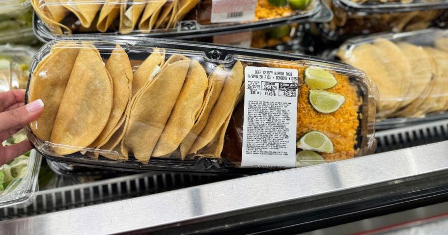 A large portion of tacos in a plastic container in a store