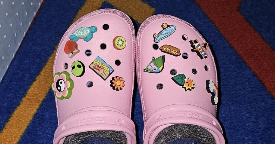 crocs jibbitz charms on pink pair of clogs