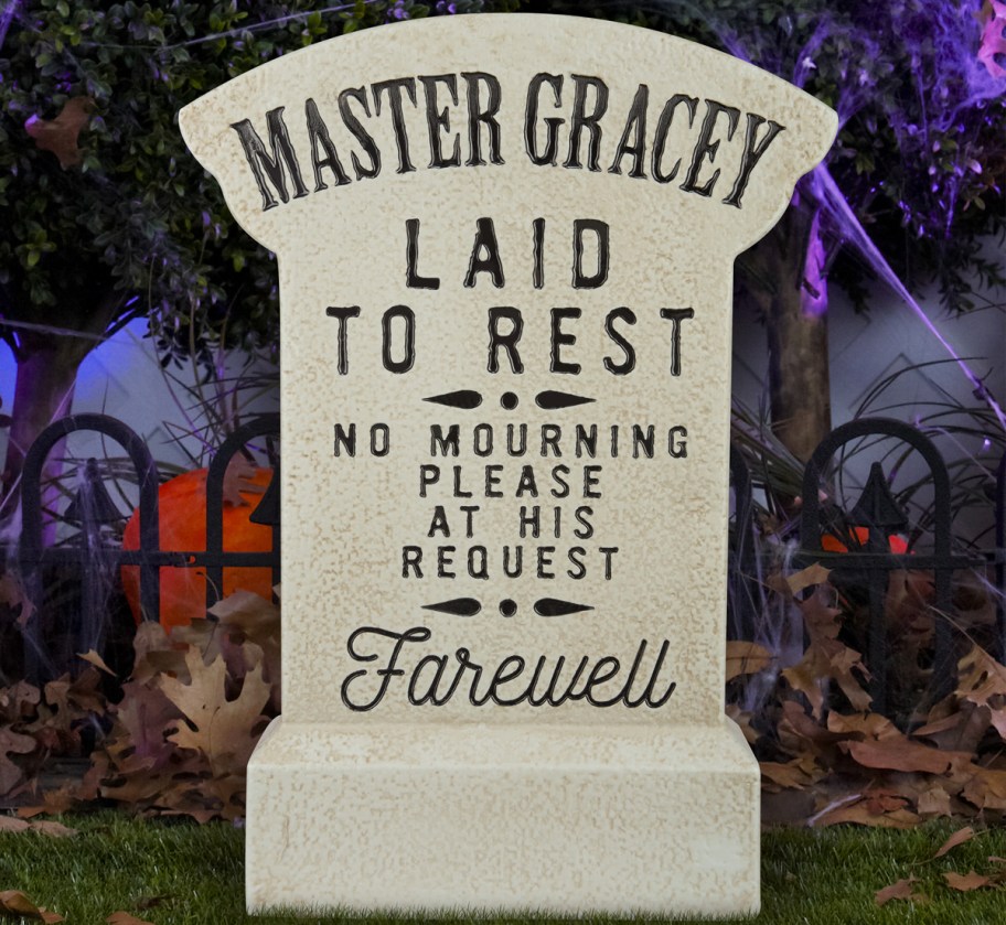 Haunted Mansion Master Gracey Tombstone Blow Mold in yard with cobwebs