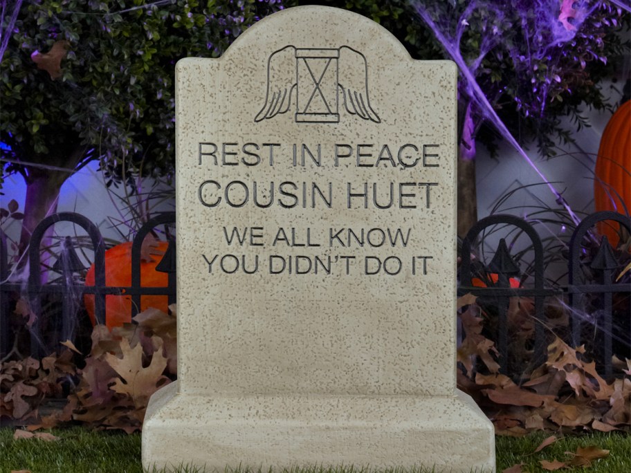 Haunted Mansion Cousin Huet Tombstone Blow Mold in yard with cobwebs