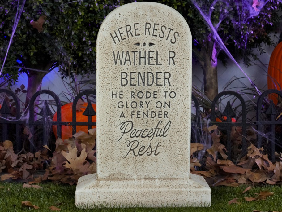 Haunted Mansion Wathel Bender Tombstone Blow Mold in yard with cobwebs