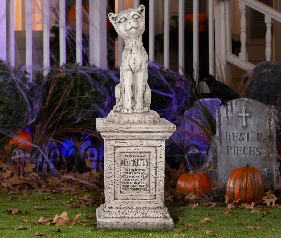 Haunted Mansion Cat Tombstone Blow Mold in yard with pumpkins
