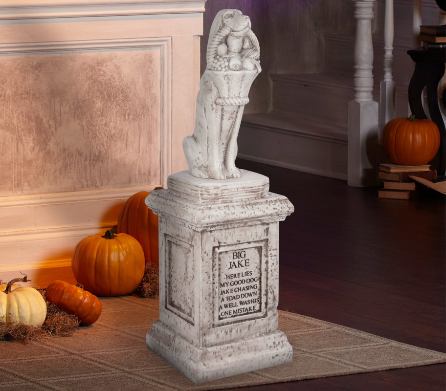 Haunted Mansion Dog Tombstone Blow Mold with pumpkins behind it