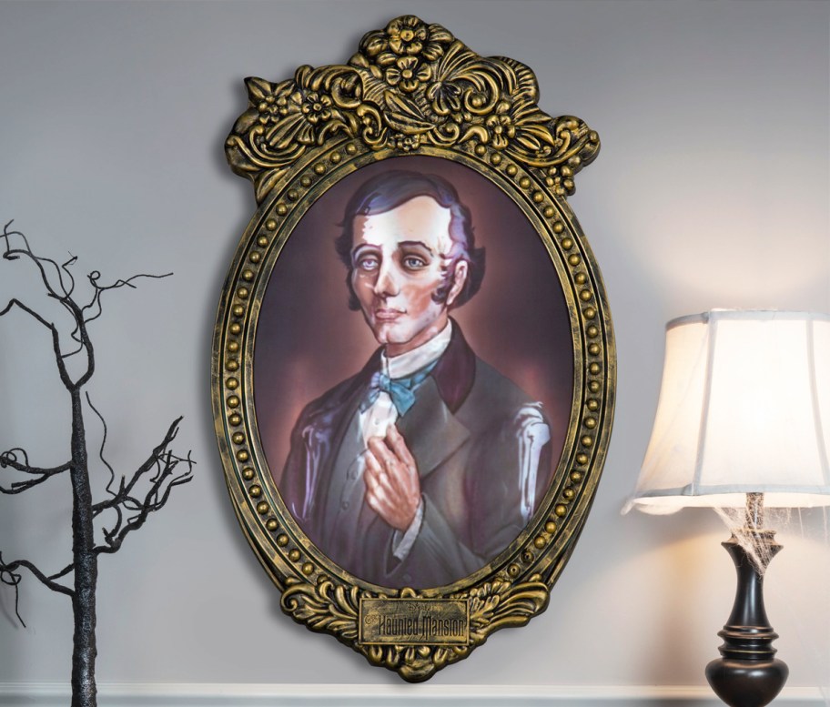 Haunted Mansion framed photo decoration on wall near lamp and decorative tree