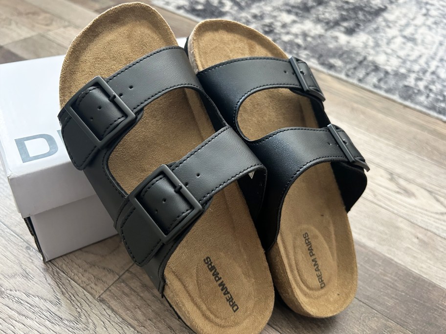 pair of black double buckle footbed sandals