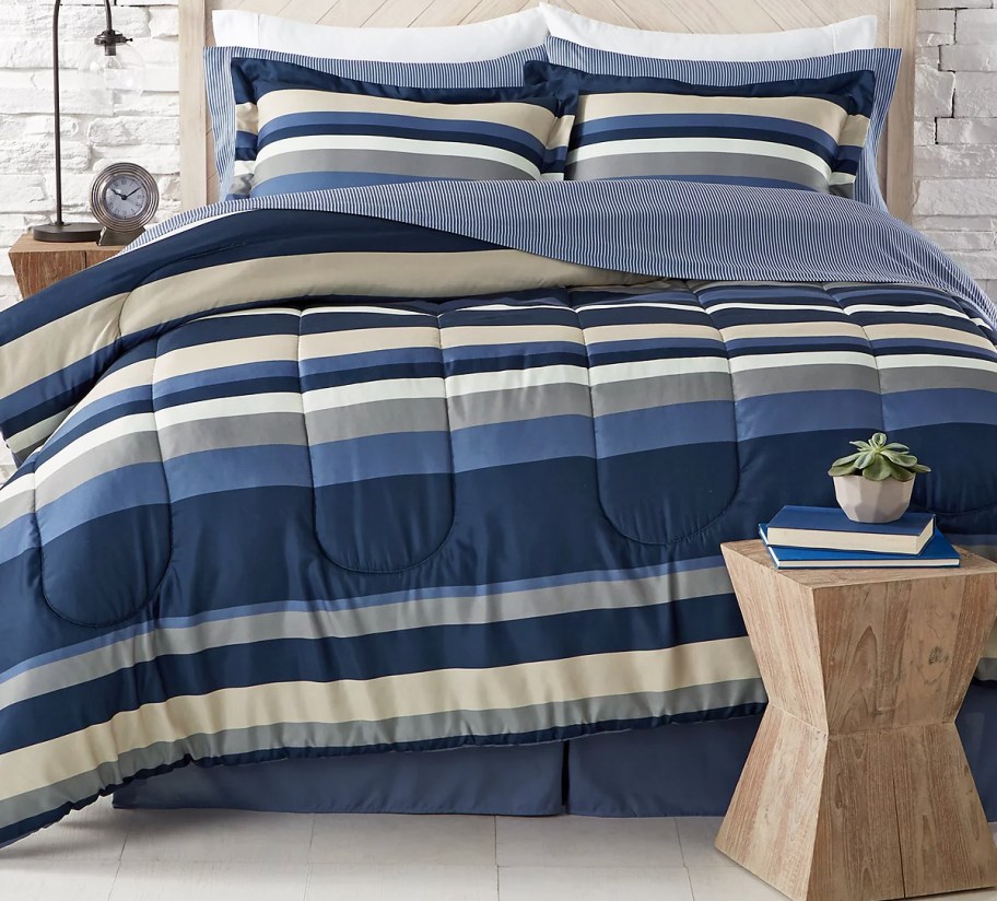 blue and tab striped comforter set on bed with matching pillow shams
